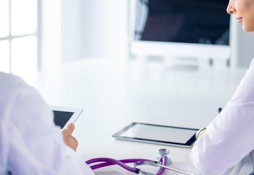 Medical team sitting and discussing at table.