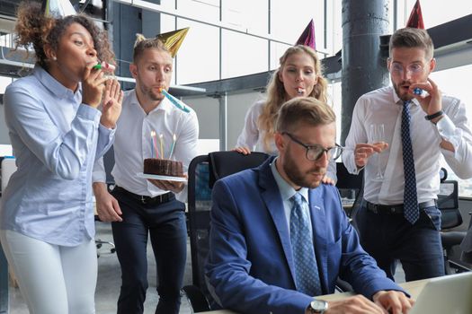 Business team celebrating a birthday of collegue in the modern office.