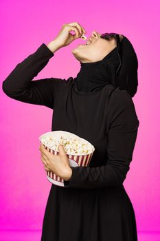 arab woman attractive look popcorn glasses movie watching studio lifestyle. High quality photo
