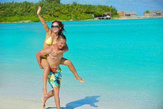 happy young asian couple have fun and romantic time at  summer on beautiful white sand beach