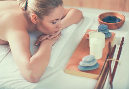 Young woman getting spa massage, lying on spa salon