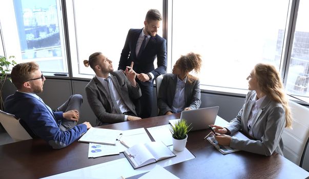 Business people discussing together in conference room during meeting at office.