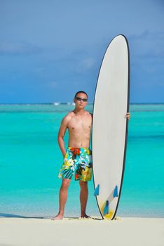 Man with surf board on beautiful tropical beach  beach