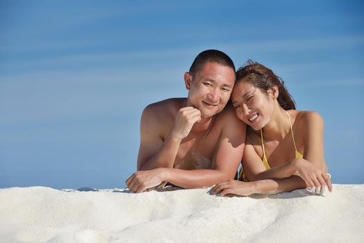 happy young asian couple have fun and romantic time at  summer on beautiful white sand beach