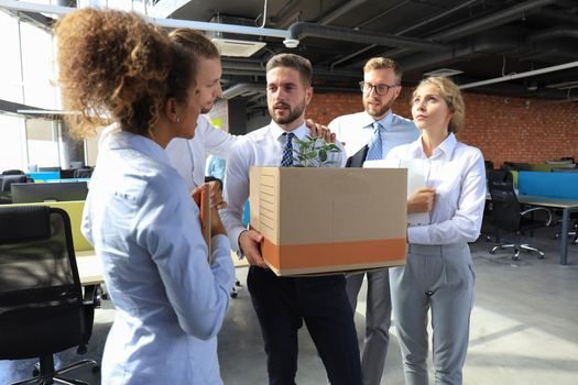 Business colleagues say goodbye to the dismissed employee.