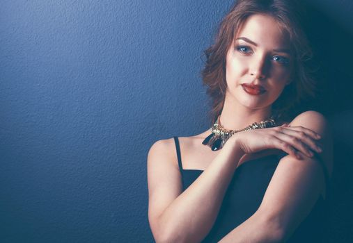 Beautiful woman with evening make-up in black dress.