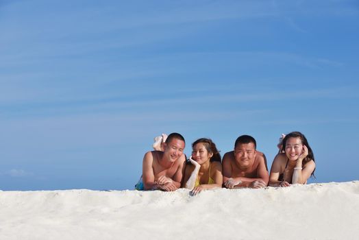 group of happy young people have fun and joy at the  white sand  beach on beautiful summer  day