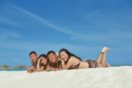 group of happy young people have fun and joy at the  white sand  beach on beautiful summer  day