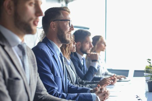 Image of row of business people working at seminar