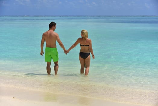 happy young  couple at summer vacation have fun and relax at beautiful sunny  day on beach