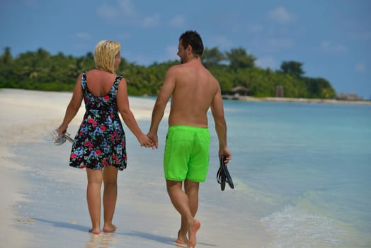 happy young  couple at summer vacation have fun and relax at beautiful sunny  day on beach