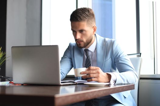 Modern businessman thinking about something while sitting in the office.