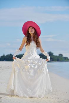 asian  bride with a veil on the beach in the sky and blue sea. honeymoon on the fantastic island at summer