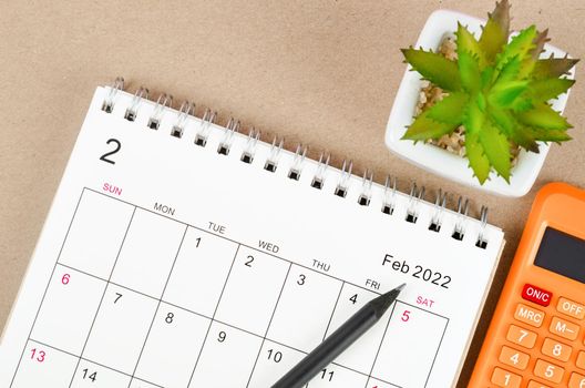 The February 2022 desk calendar with calculator.