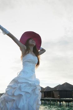 asian  bride with a veil on the beach in the sky and blue sea. honeymoon on the fantastic island at summer