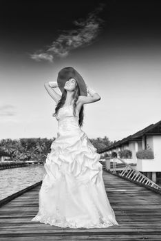 asian  bride with a veil on the beach in the sky and blue sea. honeymoon on the fantastic island at summer