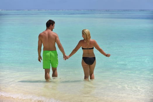 happy young  couple at summer vacation have fun and relax at beautiful sunny  day on beach