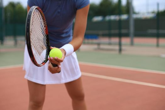 Close up of a tennis player hitting the ball with racket