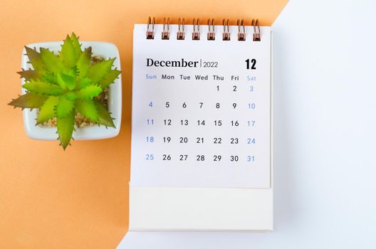 The December 2022 desk calendar with tree pot.