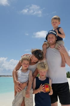 Portrait of a happy family on summer vacation  at beach