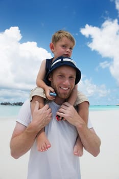 Portrait of a happy family on summer vacation  at beach