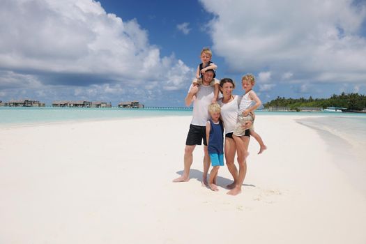 Portrait of a happy family on summer vacation  at beach