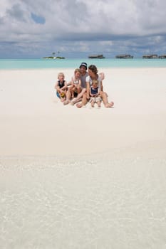 Portrait of a happy family on summer vacation  at beach