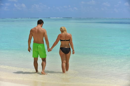 happy young  couple at summer vacation have fun and relax at beautiful sunny  day on beach