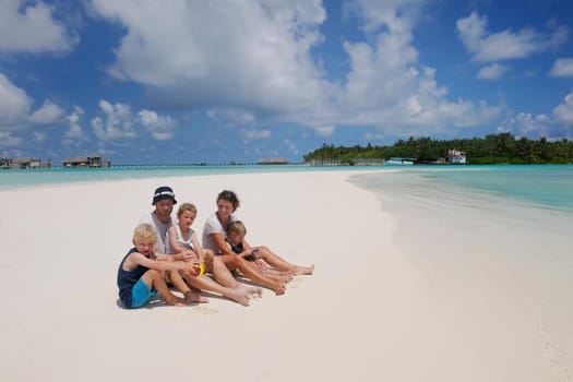 Portrait of a happy family on summer vacation  at beach