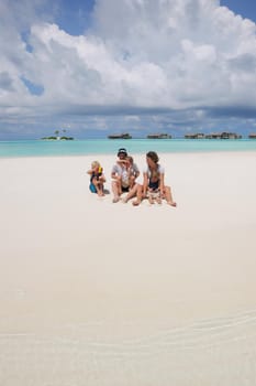 Portrait of a happy family on summer vacation  at beach