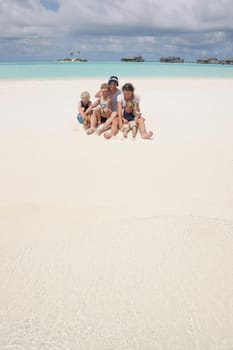 Portrait of a happy family on summer vacation  at beach