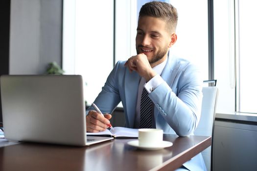 Modern businessman thinking about something while sitting in the office.