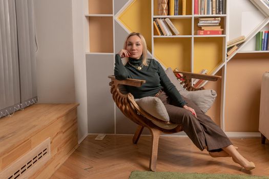 Woman sits on a chair girl business internet, technology beauty attractive happy, positive work. Posing feminine color, style joyful