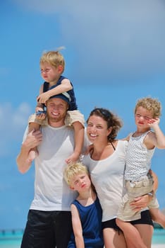 Portrait of a happy family on summer vacation  at beach