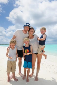 Portrait of a happy family on summer vacation  at beach