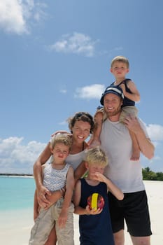 Portrait of a happy family on summer vacation  at beach