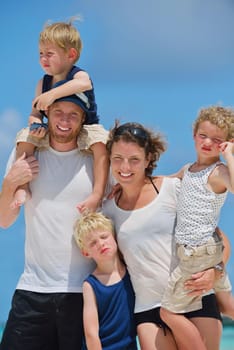 Portrait of a happy family on summer vacation  at beach