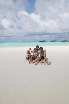 Portrait of a happy family on summer vacation  at beach