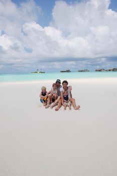 Portrait of a happy family on summer vacation  at beach