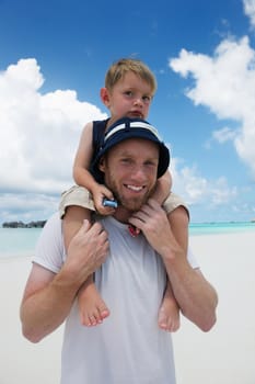 Portrait of a happy family on summer vacation  at beach