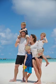 Portrait of a happy family on summer vacation  at beach