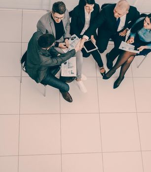 top view. a group of business people discussing business documents . photo with a copy of the space