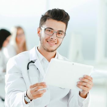 smiling doctor looking at the digital tablet screen .photo with copy space