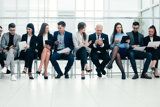 group of employees using their devices in the conference room. photo with a copy of the space