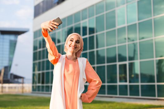 Young muslim woman take self portrait outdoor