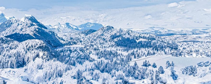 Winter wonderland and magical Christmas landscape. Snowy mountains and forest covered with snow as holiday background.