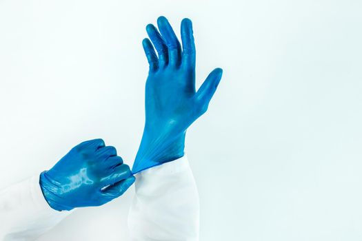 close up. doctor putting on protective gloves. photo with a copy-space.