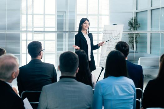 rear view. businesswoman making a presentation for the employees of the company