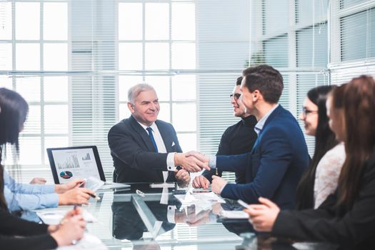 business colleagues shaking hands during a work meeting. the concept of teamwork