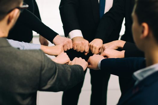 close up. group of young employees standing in a circle . the concept of teamwork